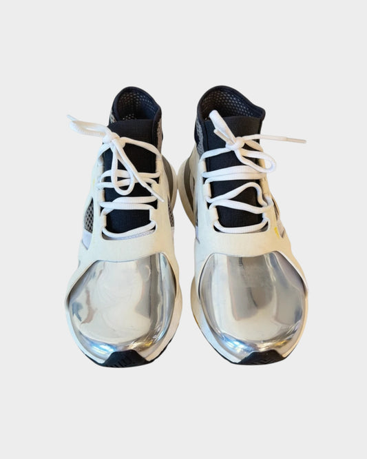 Lula and Mimi Adidas x Stella McCartney Ultraboost sneakers with white mesh, black accents, and metallic silver toe caps.