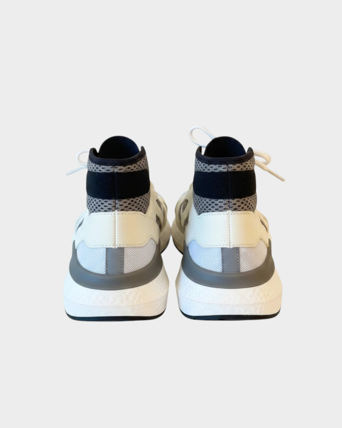 Lula and Mimi Adidas x Stella McCartney Ultraboost sneakers in white and black, rear view showing mesh and boost sole.