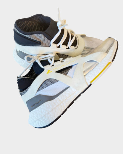 Lula and Mimi Adidas x Stella McCartney Ultraboost sneakers in white and black with a metallic silver toe cap.