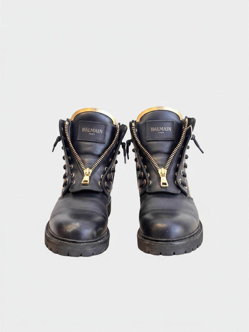 Lula and Mimi Balmain black leather combat boots with gold front zippers and stud detailing on a chunky lug sole.
