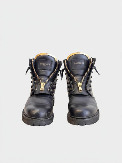 Lula and Mimi Balmain black leather combat boots with gold front zippers and stud detailing on a chunky lug sole.