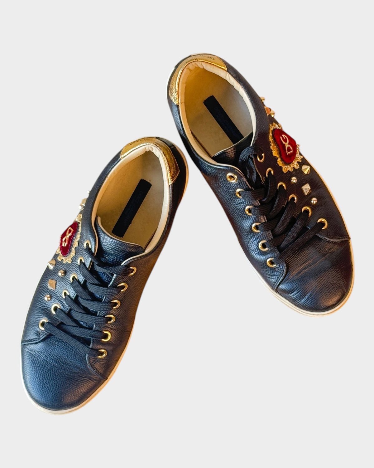 Lula and Mimi Dolce & Gabbana Portofino black leather sneakers featuring a sequined velvet heart and gold-tone studs.