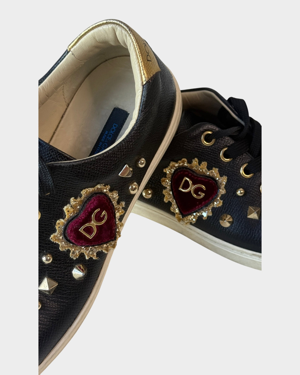 Lula and Mimi Dolce & Gabbana black leather Portofino sneakers featuring a sequined velvet DG heart and gold studs.