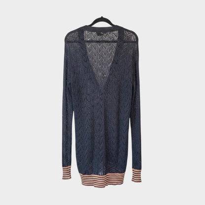Lula and Mimi Kate Sylvester black luxury yarn cardigan with v-neck and striped cuffs hanging on a black hanger