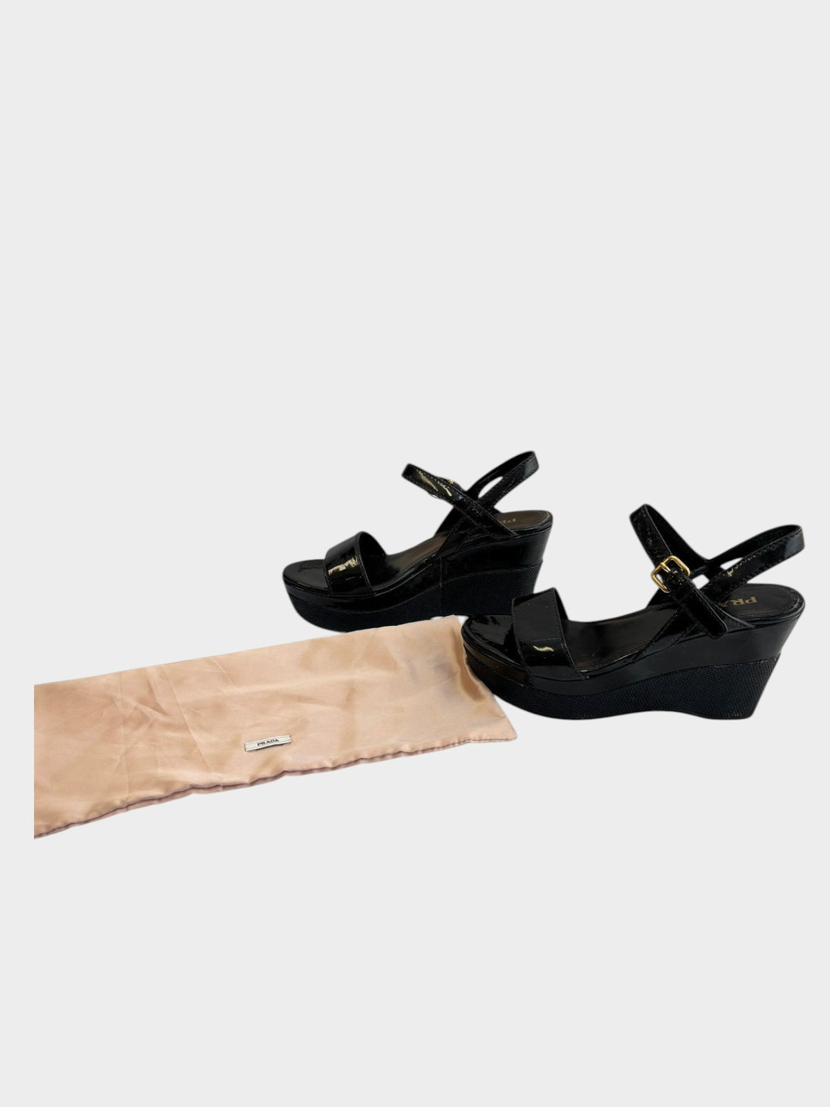 Lula and Mimi Prada Sport black patent leather platform wedge sandals with gold-tone buckle and branded dust bag.