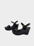 Lula and Mimi Prada Sport black patent leather platform wedge sandals with gold-tone ankle strap buckles.