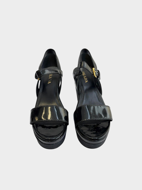 Lula and Mimi Prada Sport black patent leather platform wedge sandals with gold-tone buckle ankle straps.