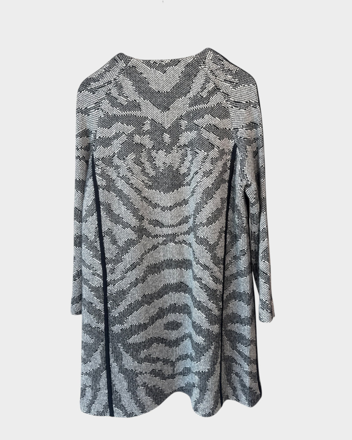 Lula and Mimi Thurley longline knit coat in a grey and black animal print pattern hanging on a wooden hanger.