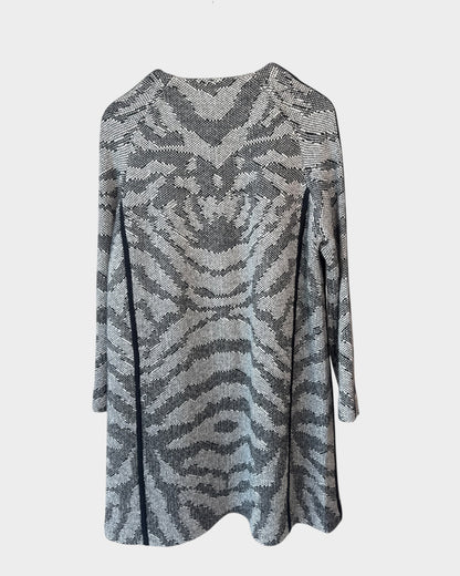 Lula and Mimi Thurley longline knit coat in a grey and black animal print pattern hanging on a wooden hanger.