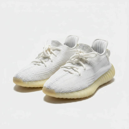 Lula and Mimi Adidas x Yeezy Boost 350 V2 trainers in cream white featuring a breathable knit upper and rubber sole.