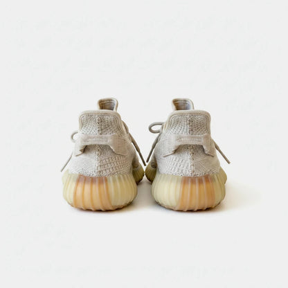Lula and Mimi Adidas x Yeezy Boost 350 V2 Sesame sneakers in beige Primeknit with signature ribbed gum soles