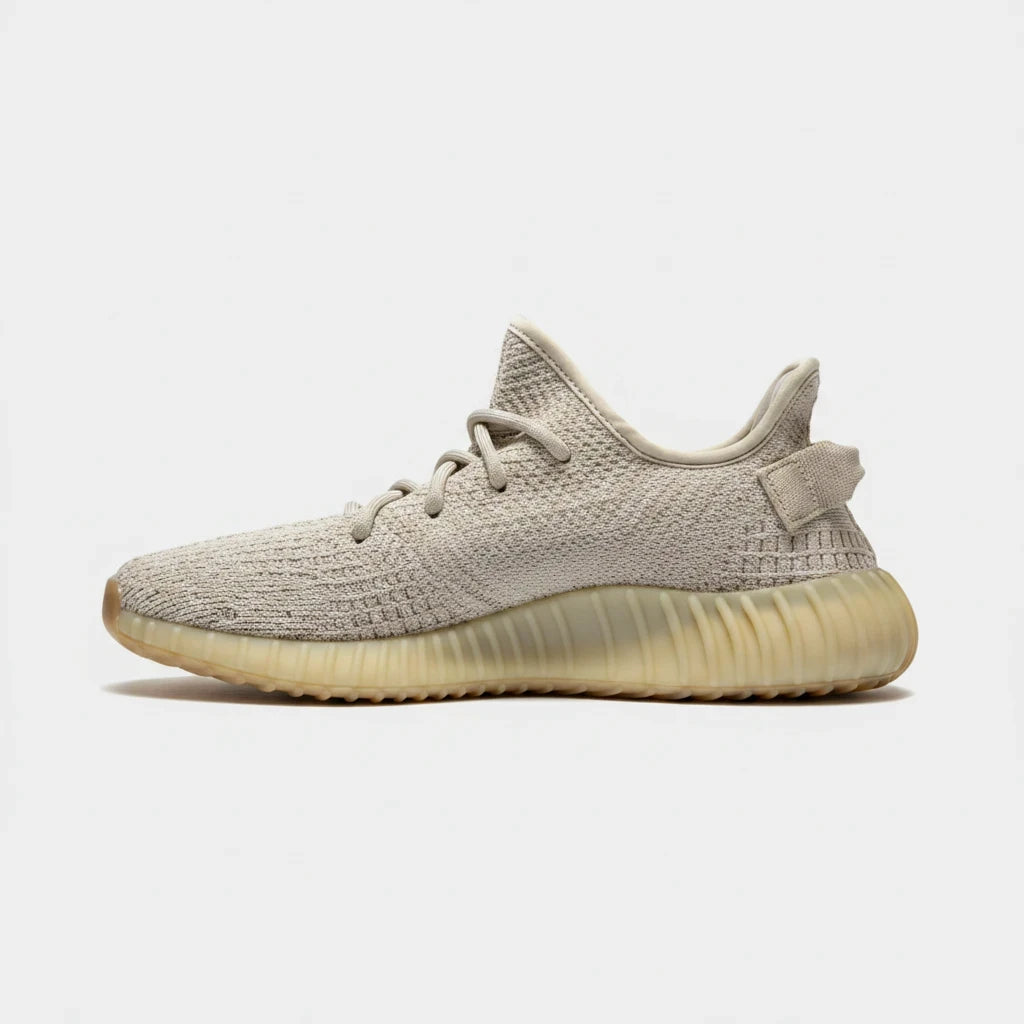 Lula and Mimi Adidas x Yeezy Boost 350 V2 sneakers in sesame beige Primeknit with a tonal rubber sole, side view.