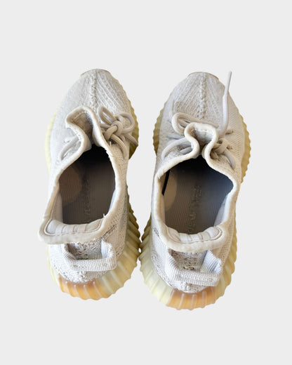 Lula and Mimi Adidas x Yeezy Boost 350 V2 Sesame sneakers in beige Primeknit with signature Boost soles, top view.