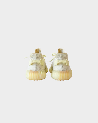 Lula and Mimi Adidas x Yeezy Boost 350 V2 Butter trainers in pale yellow knit fabric, rear view showing sole detail.