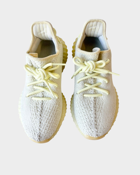 Lula and Mimi Adidas x Yeezy Boost 350 V2 Butter trainers in pale yellow knit with matching laces and rubber soles.