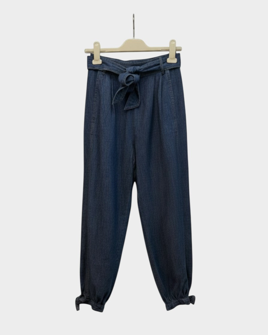 Preloved Zimmermann Alight dark wash denim harem pants with tie waist and gathered ankle cuffs, front view — Lula and Mimi designer consignment
