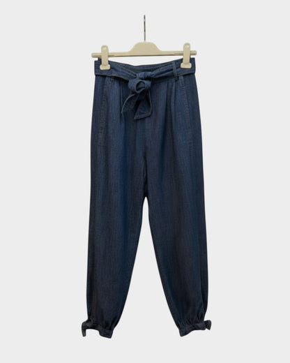 Preloved Zimmermann Alight dark wash denim harem pants with tie waist and gathered ankle cuffs, front view — Lula and Mimi designer consignment