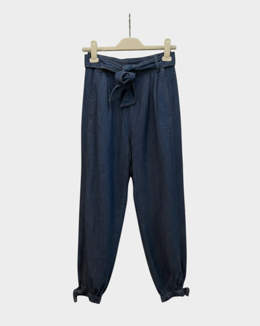 Preloved Zimmermann Alight dark wash denim harem pants with tie waist and gathered ankle cuffs, front view — Lula and Mimi designer consignment